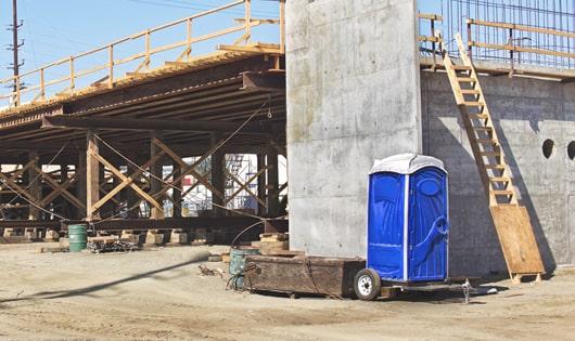 portable toilets lined up for construction workers to use